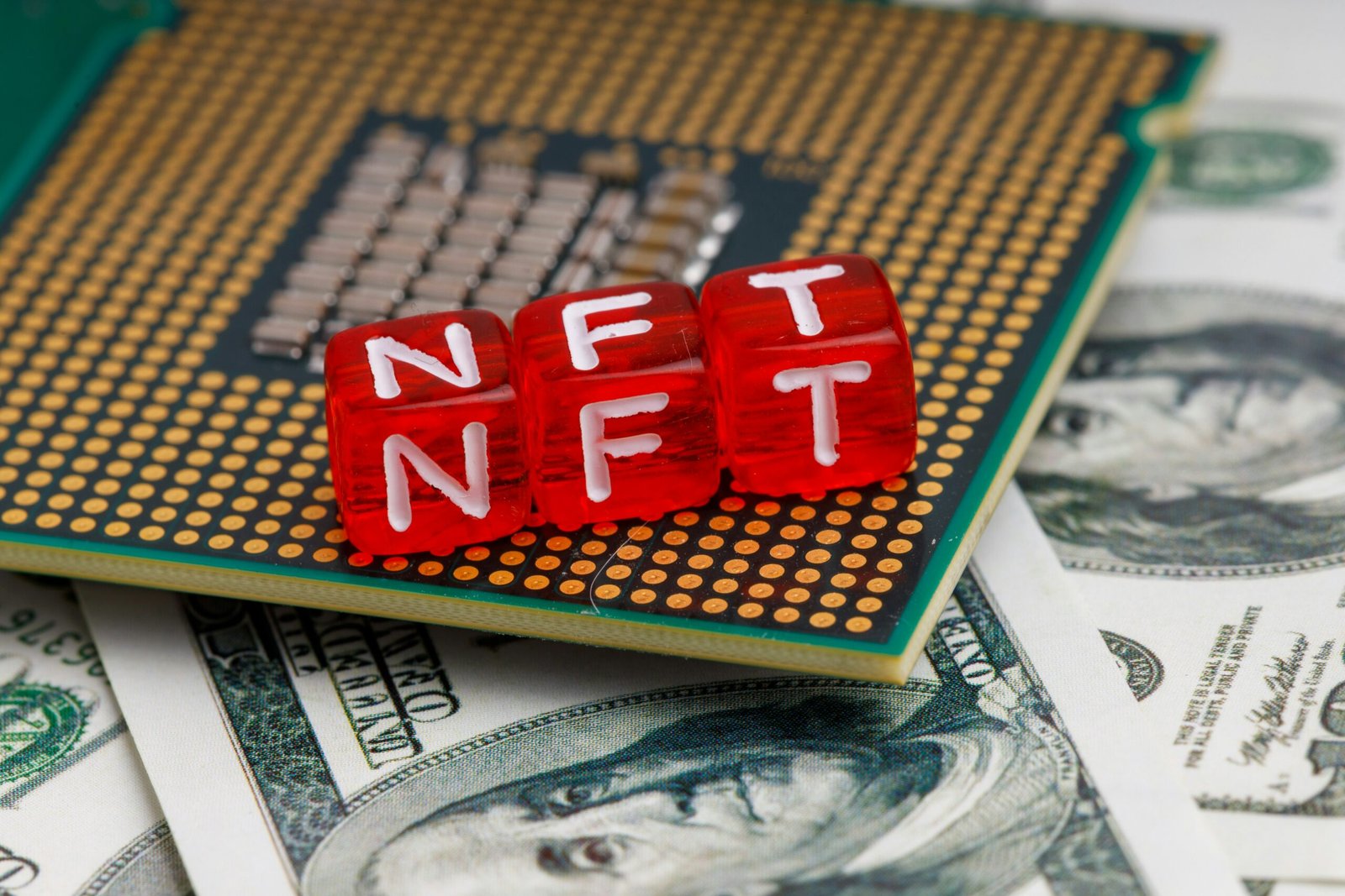 a close up of a small red block on top of a pile of money